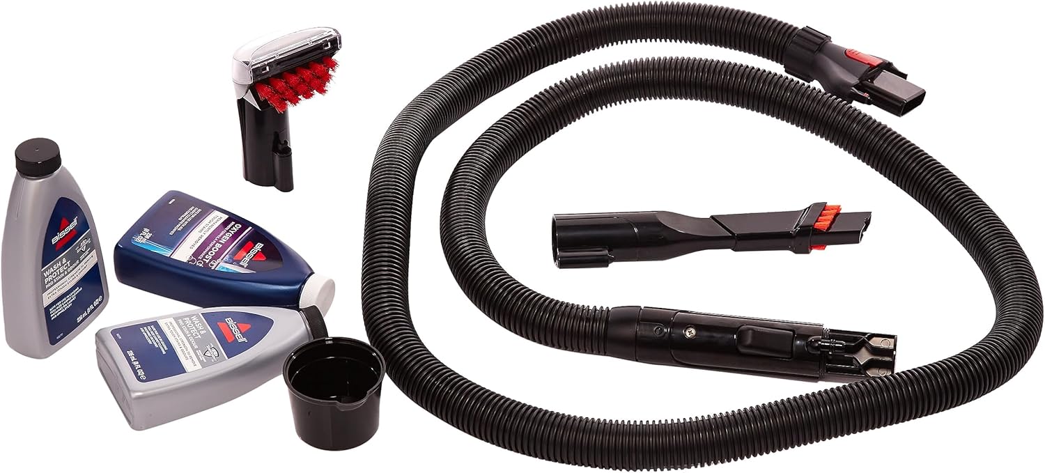 Car cleaning kit with vacuum hose, brushes, and cleaning solution bottles on a white background