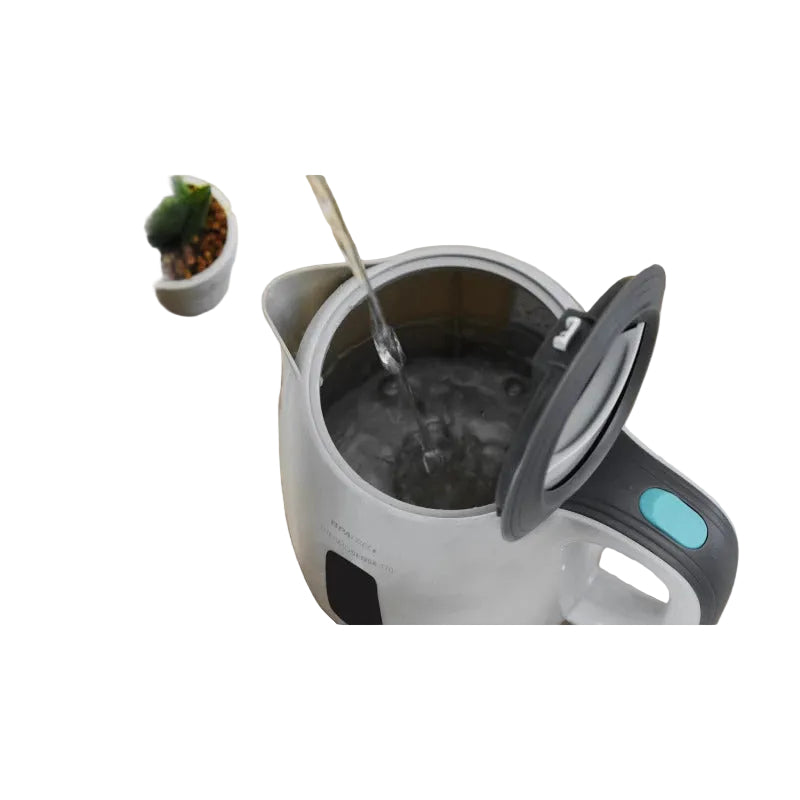 Electric kettle being filled with water on a wooden surface