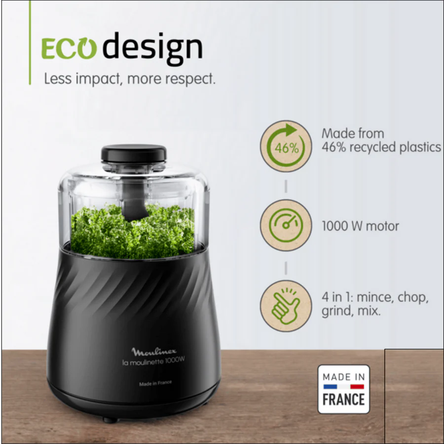 Black food processor with green herbs, 'Eco design' text, and features on a white background