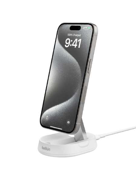 Smartphone on a white charging stand with a visible Belkin logo.