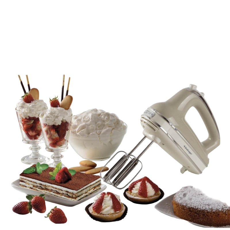 Hand mixer with desserts including tiramisu, strawberries, and a cake on a white background