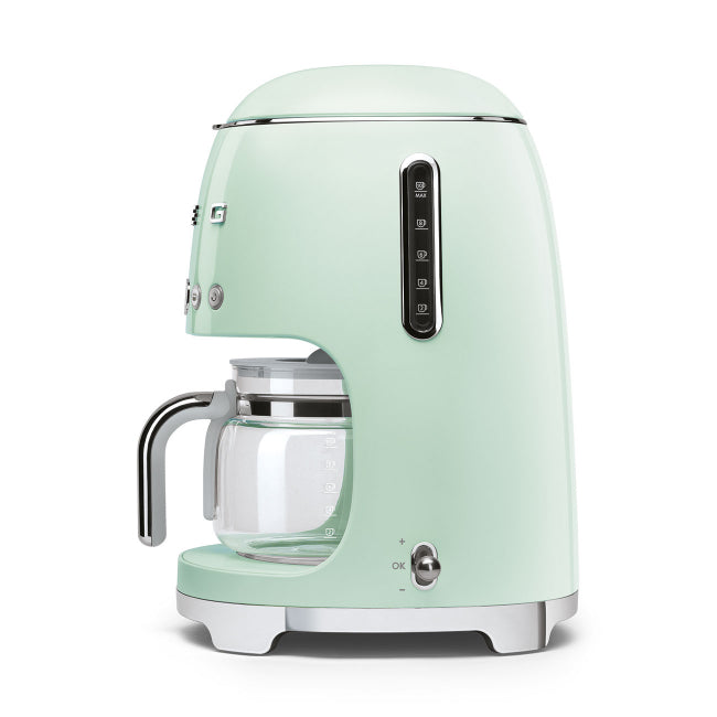 Mint green coffee machine with glass carafe on a white background