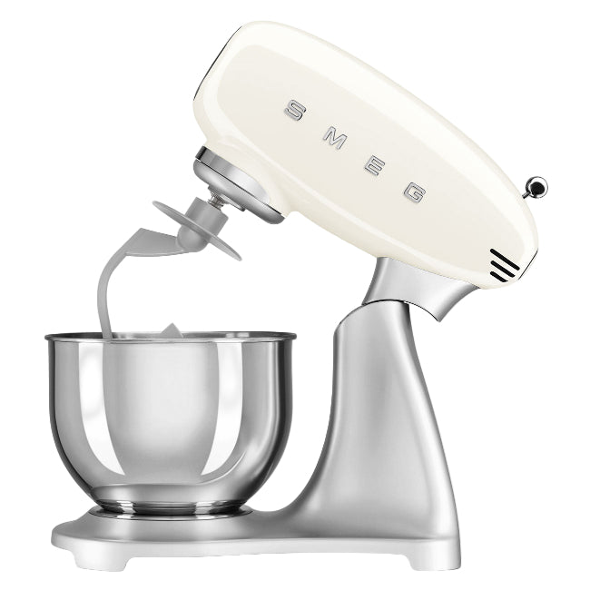 Cream-colored stand mixer with a clear bowl on a white background