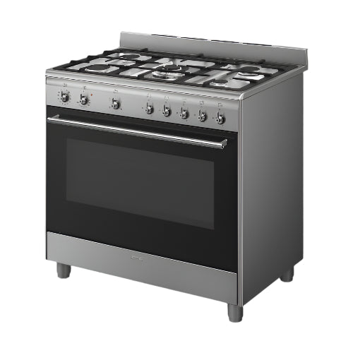 Stainless steel kitchen stove with gas cooktop on a gray background