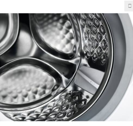 Close-up of a washing machine drum with metallic interior