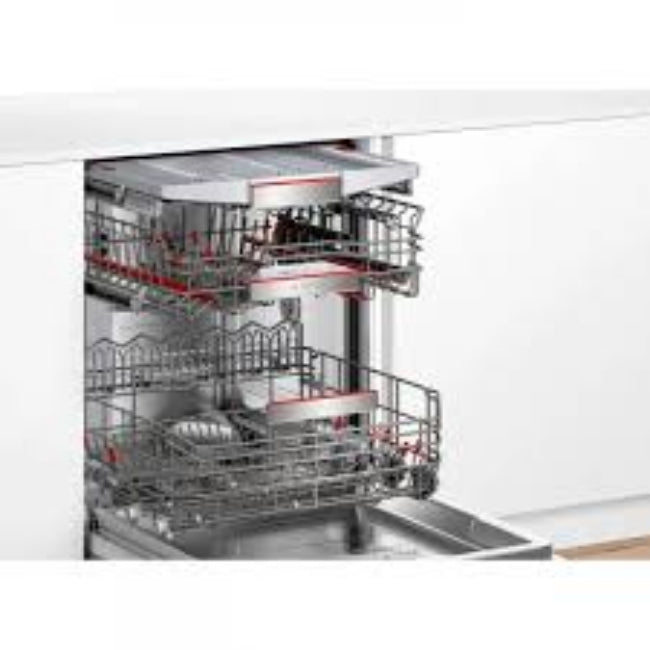 Open dishwasher with silverware and dishes inside, on a white background