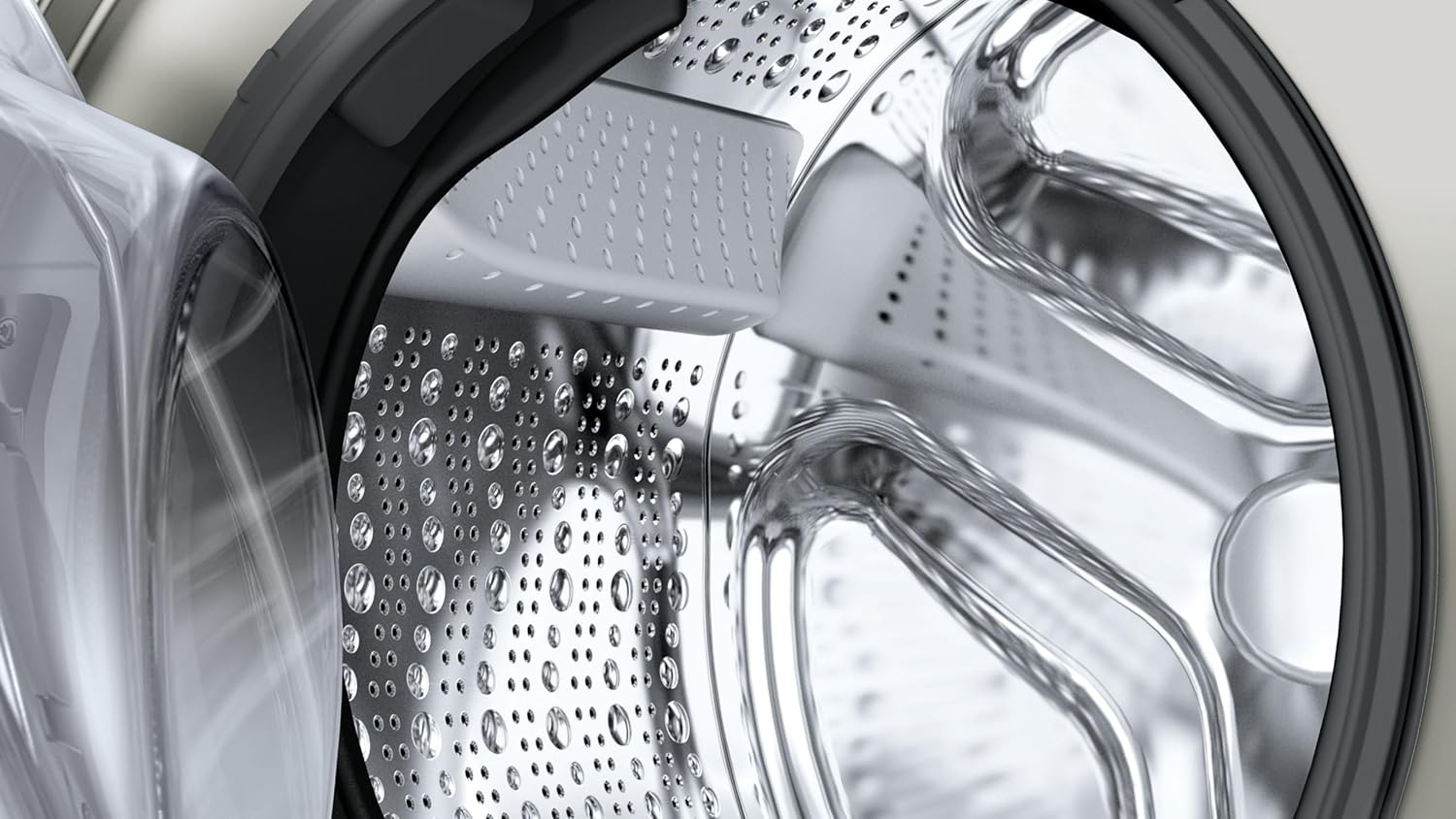 Close-up of a washing machine drum with water droplets