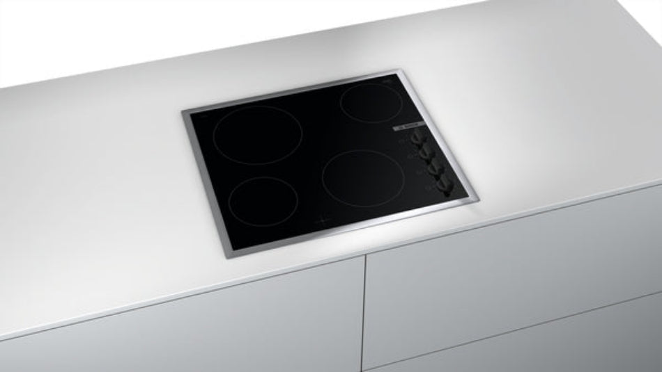 Stainless steel induction cooktop on a white kitchen countertop