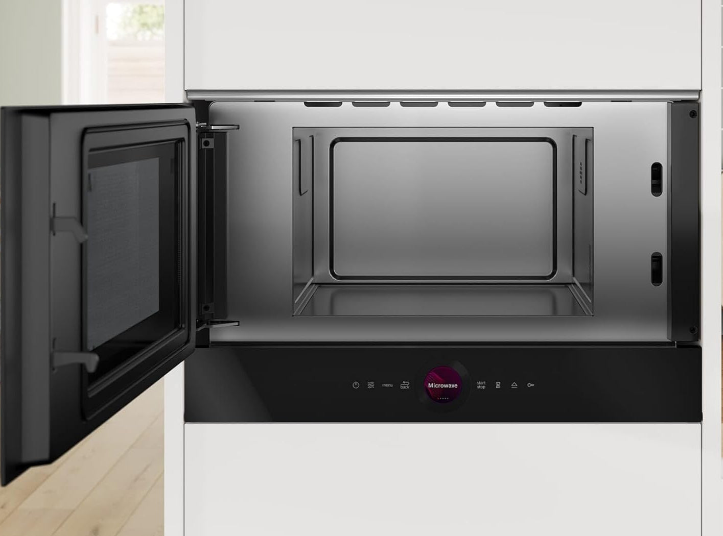 Black microwave oven with open door in a kitchen setting