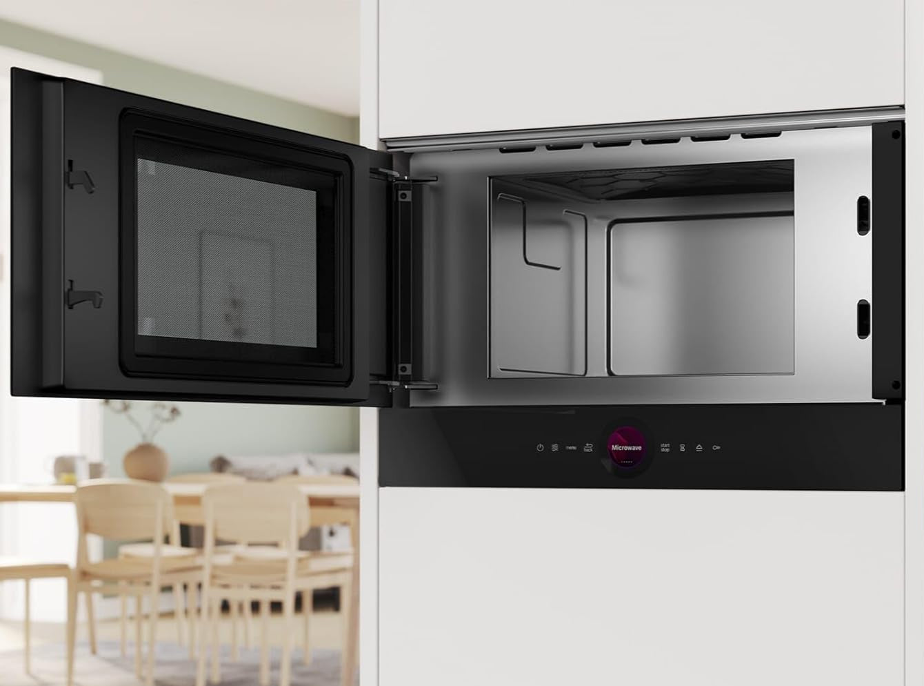 Stainless steel microwave oven with open door in a kitchen setting