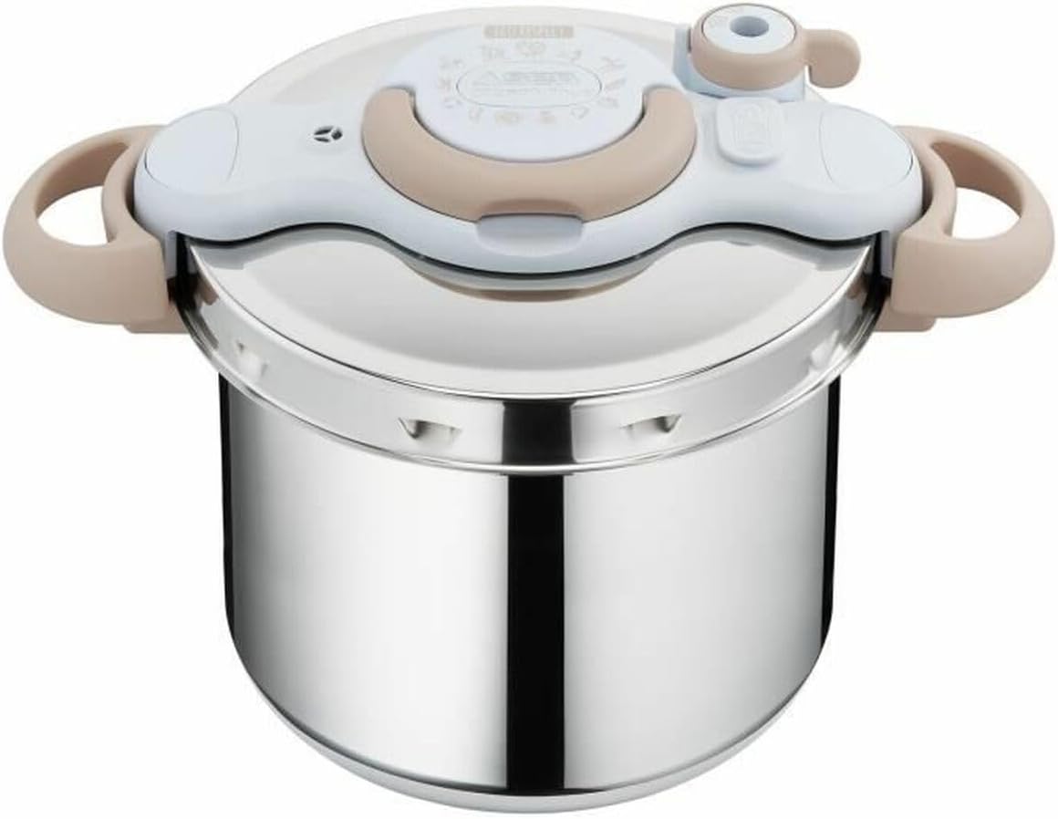 Stainless steel pressure cooker with beige handles on a white background
