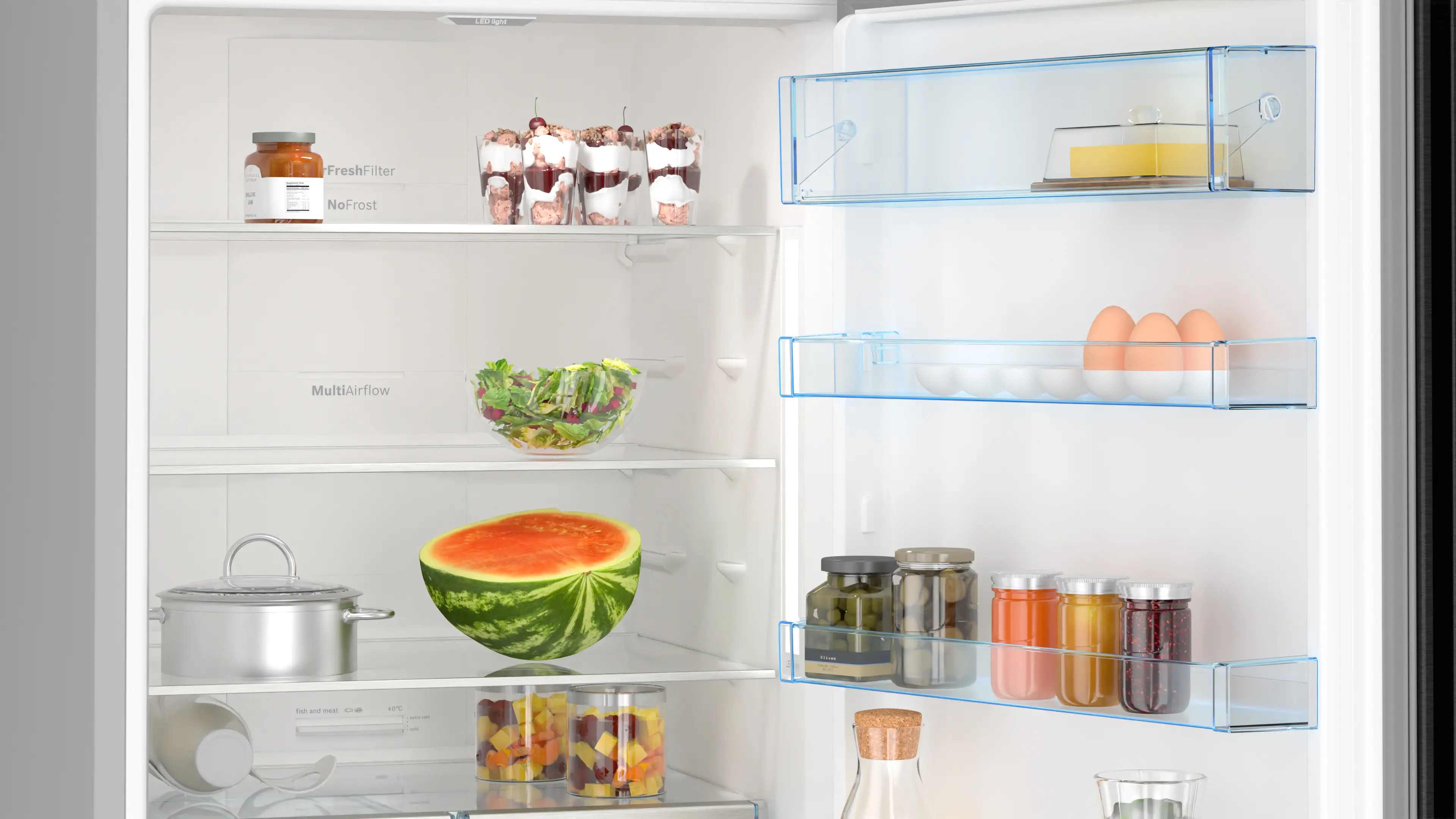 Open refrigerator with various food items inside