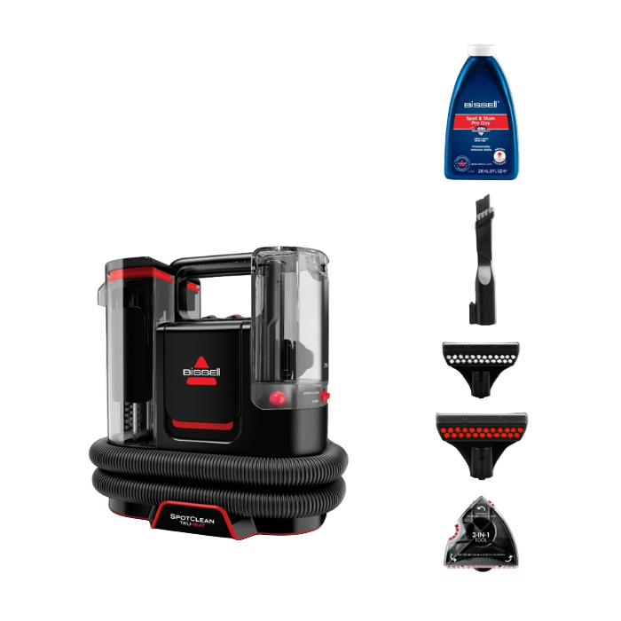 Bissell SpotClean portable carpet cleaner with attachments and cleaning solution on a white background