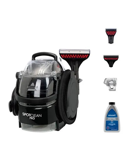 Bissell SpotClean Pro with attachments and cleaning solution on a white background