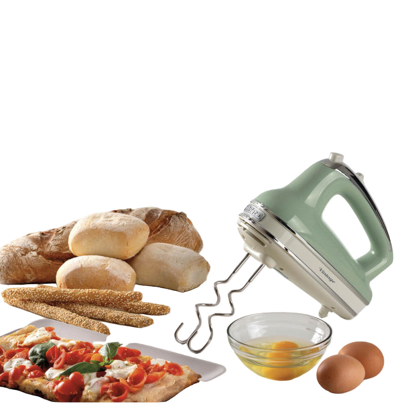 Green hand mixer with ingredients on a white background
