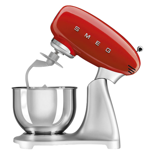 Red Smeg stand mixer with a clear mixing bowl on a white background
