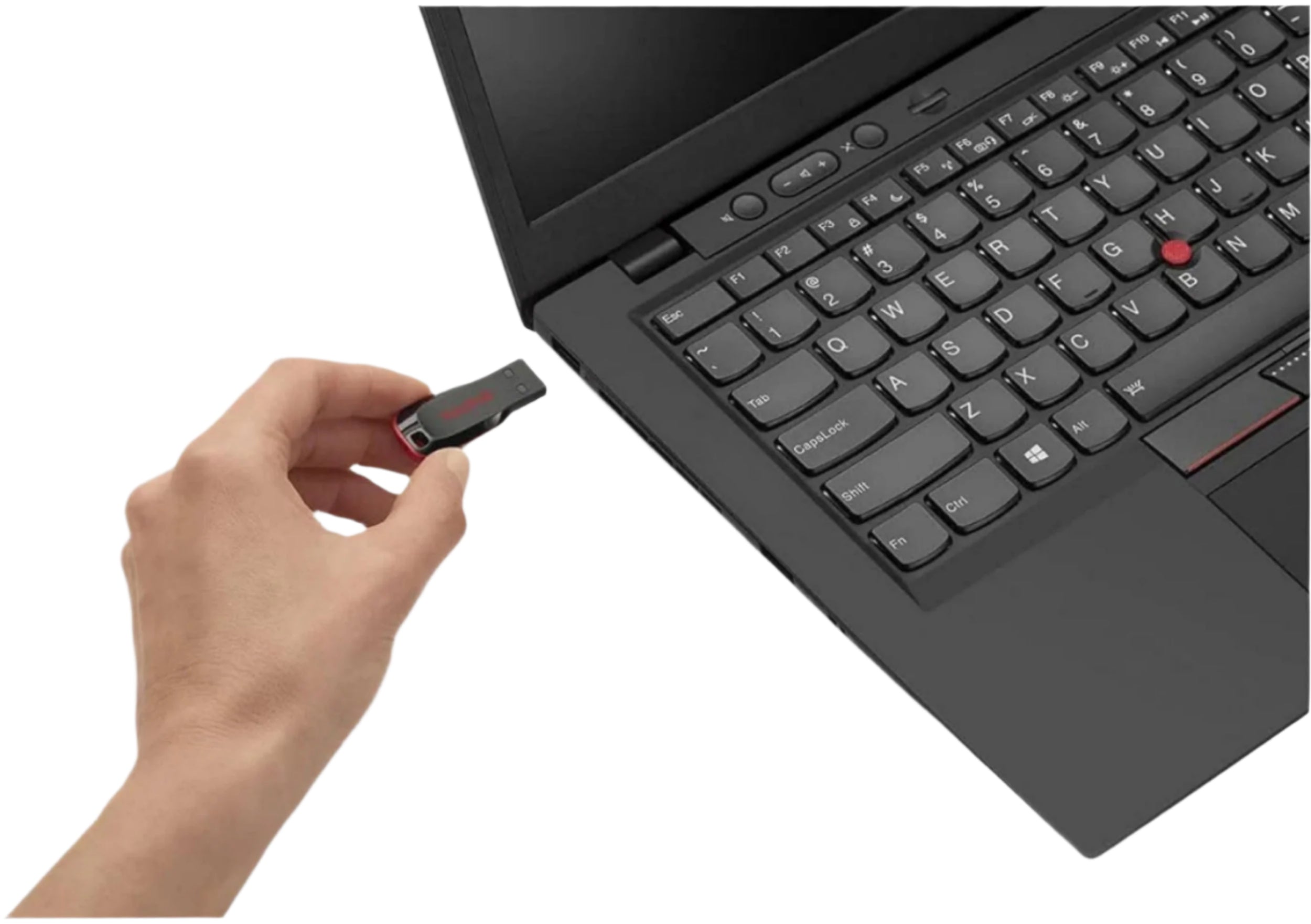 Hand holding a USB drive approaching a laptop
