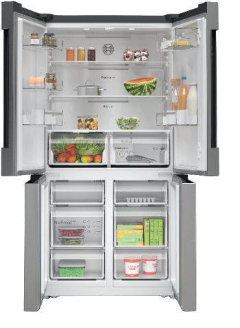 Open refrigerator with various food items inside on a white background