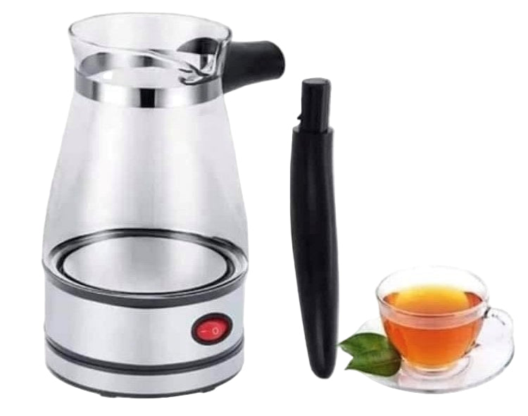 Electric kettle with a glass carafe and black handle, next to a cup of tea with a leaf on a white background.