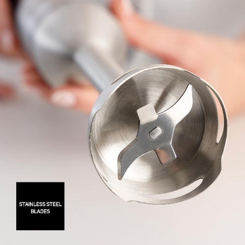 Stainless steel blades of a kitchen appliance on a neutral background