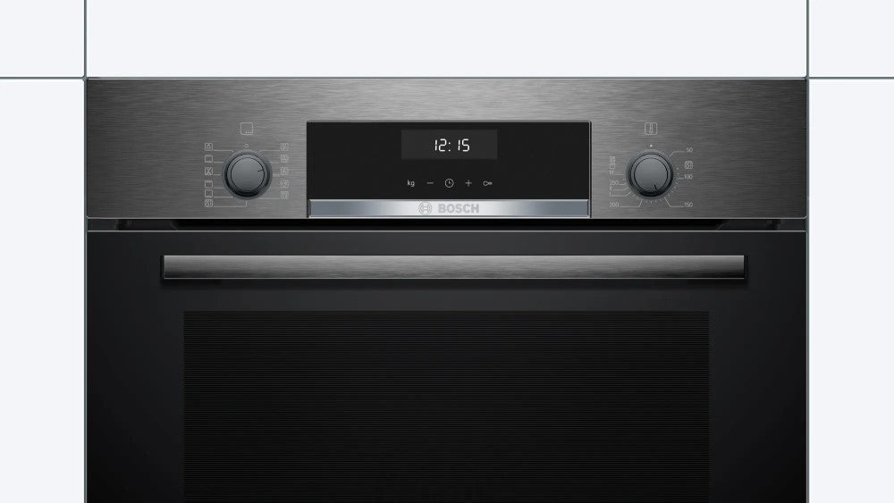 Modern black oven with digital display on a white tiled wall