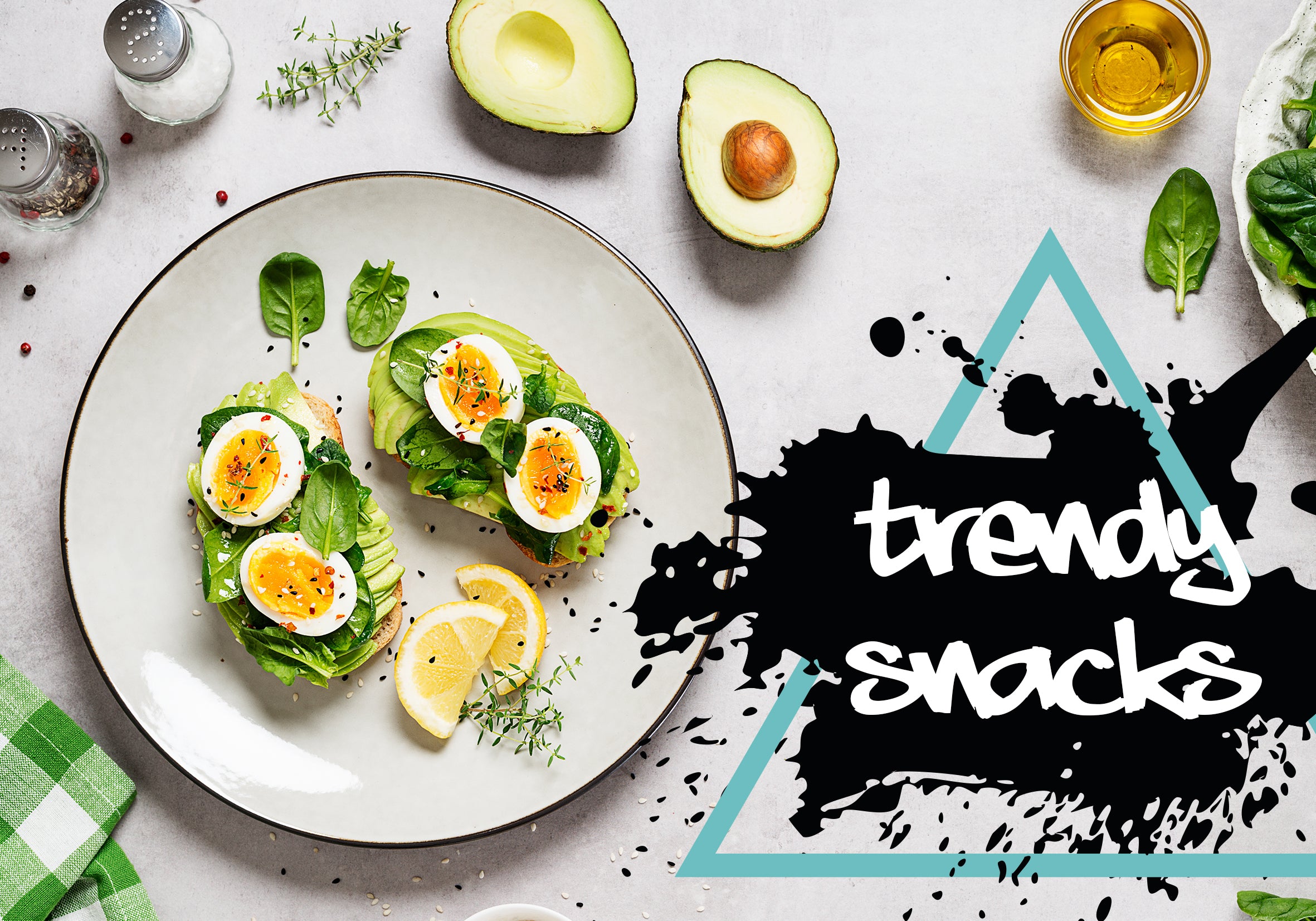 Avocado toast with eggs on a plate, surrounded by avocados, lemon, and herbs, with 'trendy snacks' text.
