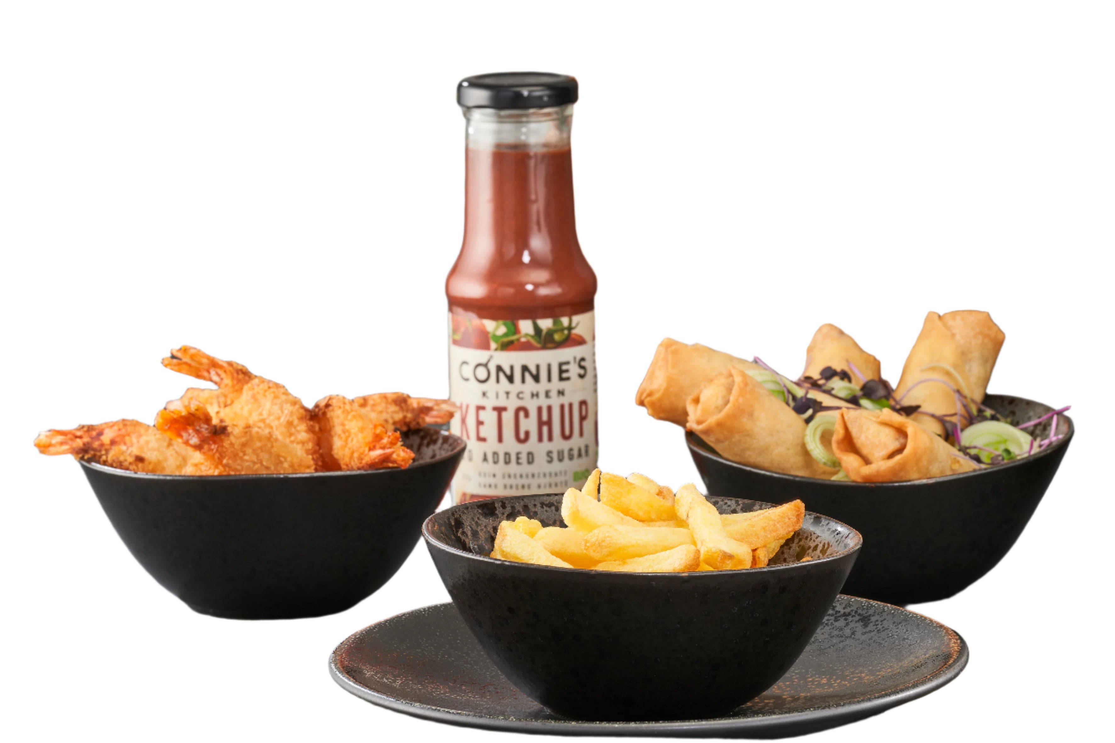Bowls of food with a bottle of ketchup on a gray surface